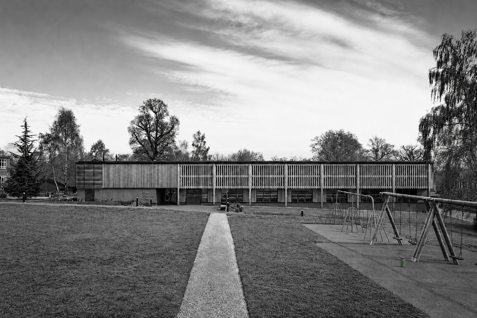 School swimming pool exterior with a timber facade and playground