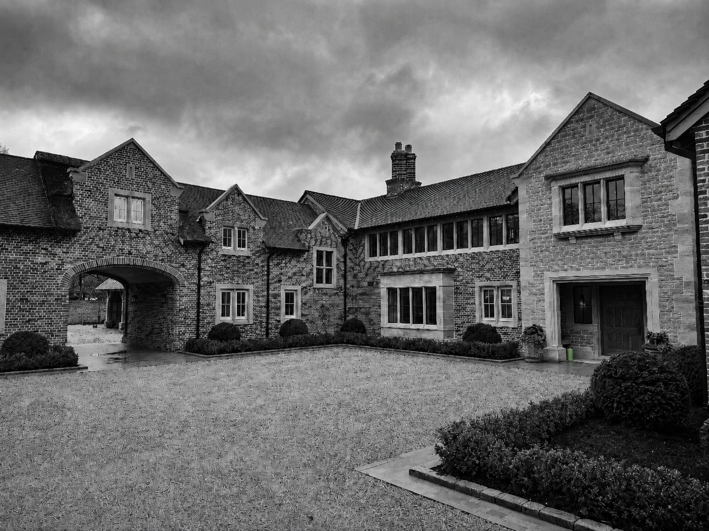High-end residential courtyard exterior with brick and stone buildings