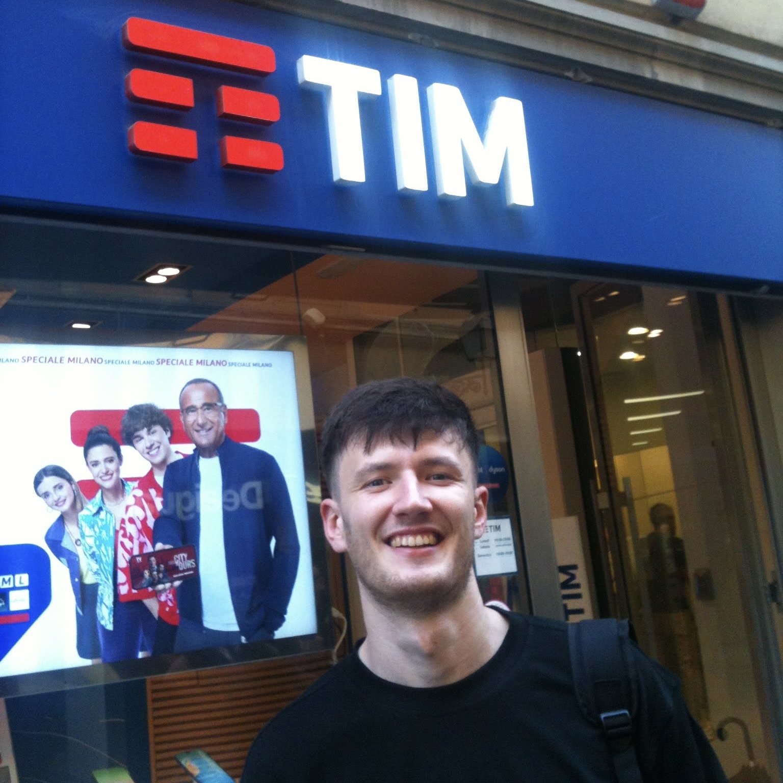 Tim standing in front of a TIM shop sign